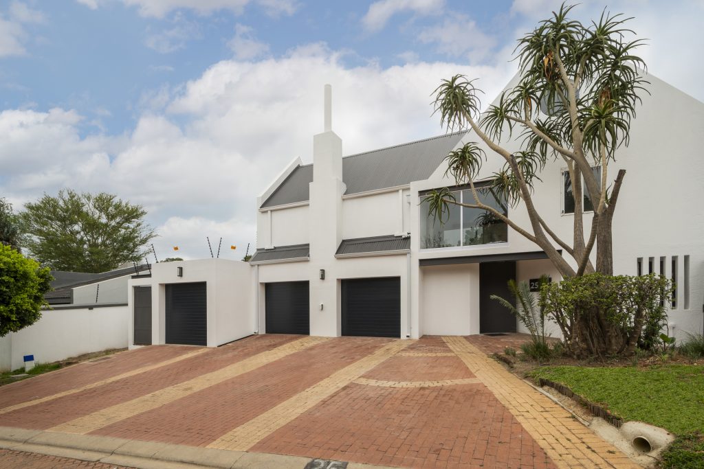 Angus10 Unified front facade with triple garage after renovation, Benmore Gardens