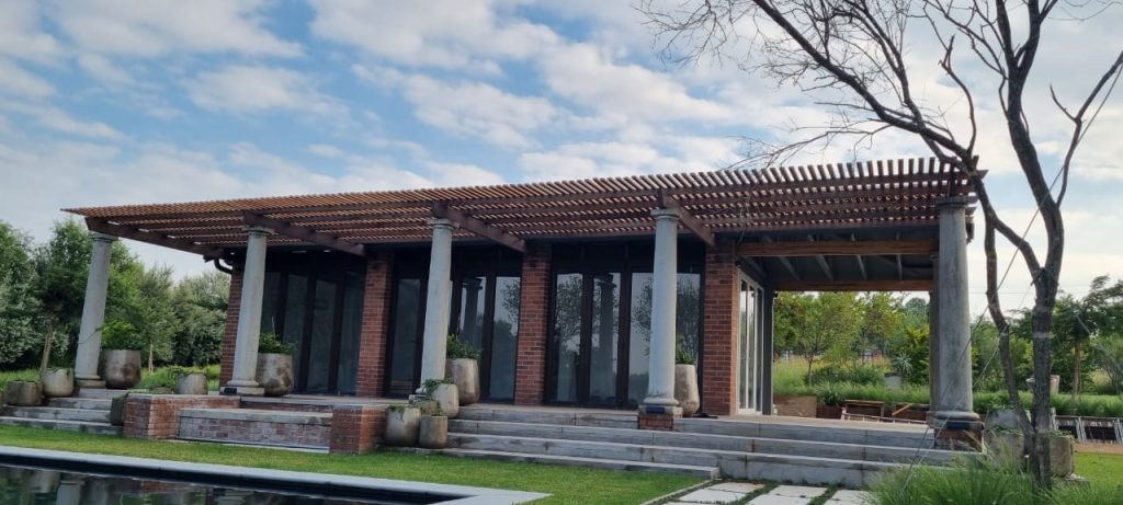 Covered entertainment area with timber-slat pergola, Saddlebrook Estate
